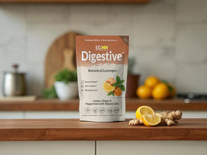 Eco Botanicals Digestive Botanical Lozenges package on kitchen counter with ginger root and lemon slices