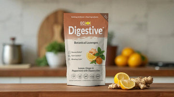 Eco Botanicals Digestive Botanical Lozenges package on kitchen counter with ginger root and lemon slices