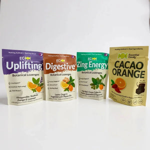 Four colorful botanical lozenge and cacao orange candy bags with natural ingredient labels on a white background