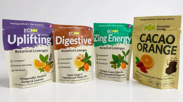 Four colorful botanical lozenge and cacao orange candy bags with natural ingredient labels on a white background