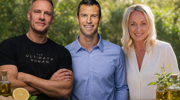 Three wellness experts standing behind a table with lemon, ginger, and botanical oils.