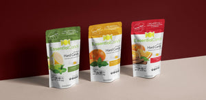 Three colorful pouches of EssentialCandy Hard Candy in various botanical flavors.