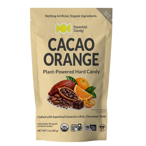 A stand-up pouch of Essential Candy Cacao Orange Plant-Powered Hard Candy, featuring a beige background with illustrations of cacao beans, oranges, chocolate, and leaves. The packaging includes certification logos and a gray 'Made in Mexico' banner.